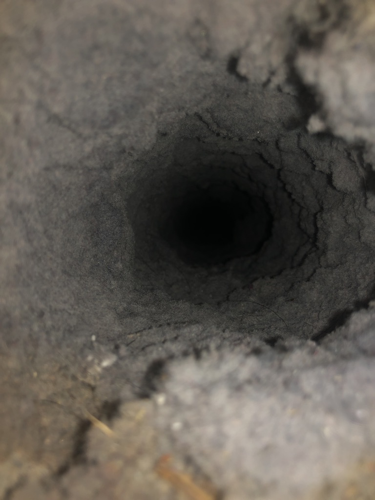 clogged, lint-filled dryer duct before duct cleaning services
