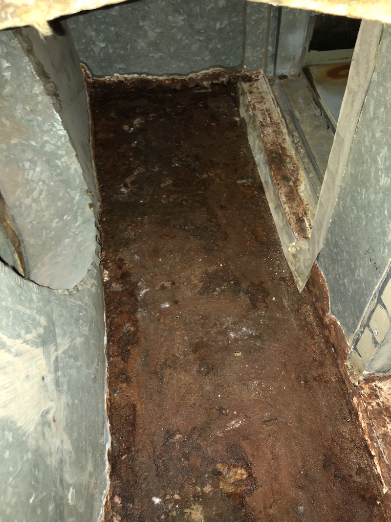 rusted air duct before cleaning and sealing
