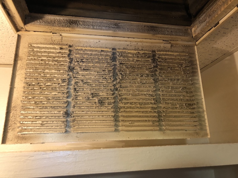 dirty air vent in drop ceiling before Duct Squads vent cleaning services in OKC